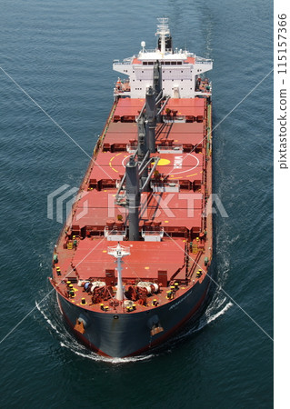 A large cargo ship approaching the Kurushima Kaikyo Bridge 115157366