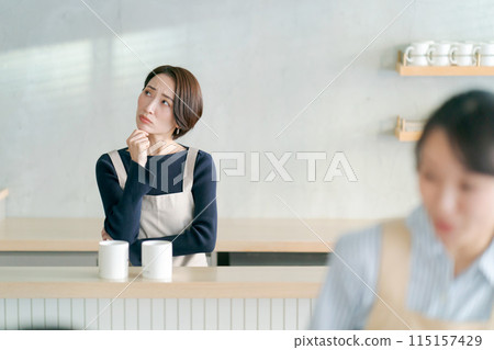 Cafe clerk with a troubled expression 115157429