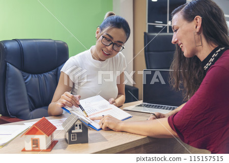 Businesswoman real estate house agent discuss to customer. Team diversity women selling house real estate agent at office desk. Women working home insurance mortgage sale apartment realtor dealership Businesswoman real estate house agent discuss to customer. Team diversity women selling house real estate agent at office desk. Women working home insurance mortgage sale apartment realtor dealership 115157515
