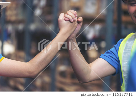 Diversity Teamwork Warehouse worker fist bump together trust partner. Engineer man, women hands partnership. Coworker colleague logistics Warehouse agreement. Multiracial Two people fist bump partner 115157711