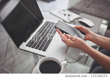 Female hands using smart phone in interior workplace, freelance business woman using cell phone at office desk, working from home using smart phone and notebook computer. Female hands using smart phone in interior workplace, freelance business woman using cell phone at office desk, working from home using smart phone and notebook computer. 115158175