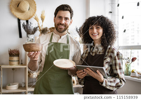 Caucasian people with tablet checking stock goods at shop. Caucasian people with tablet checking stock goods at shop. 115158939