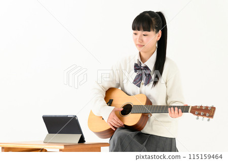 High school girl playing guitar, acoustic guitar 115159464
