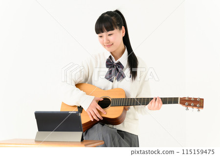 High school girl playing guitar, acoustic guitar 115159475