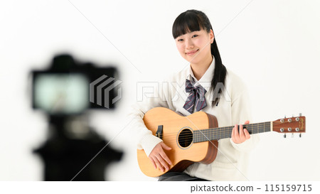 High school girl playing guitar, acoustic guitar, streaming High school girl playing guitar, acoustic guitar, streaming 115159715