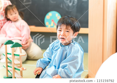 A boy in kindergarten who is fussy and crying at nursery school (the "terrible twos", crying loudly, selfish) 115159792