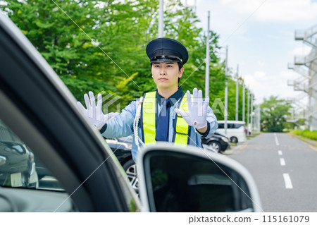 Security guard stopping a car Security guard stopping a car 115161079
