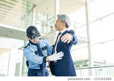 Security guard doing body check 115161088
