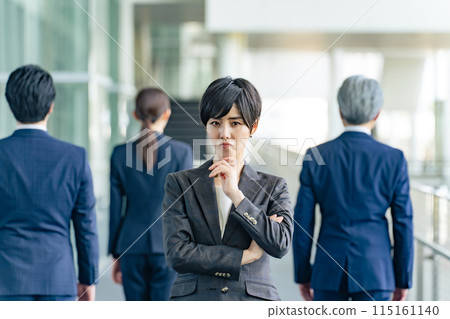 A female business person who is worried about turning her back on her colleagues 115161140