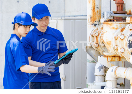 A group of engineers inspecting pipes and machinery 115161177