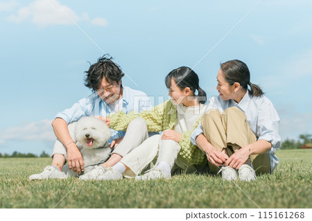 Family playing with dog/pet (owner, parents and children, 3 people) Family playing with dog/pet (owner, parents and children, 3 people) 115161268
