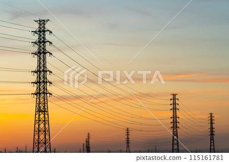 A row of power transmission towers and a sunset sky b-5 Warm colors A row of power transmission towers and a sunset sky b-5 Warm colors 115161781