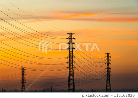 A row of power transmission towers and a sunset sky c-6 Warm colors High contrast A row of power transmission towers and a sunset sky c-6 Warm colors High contrast 115162026