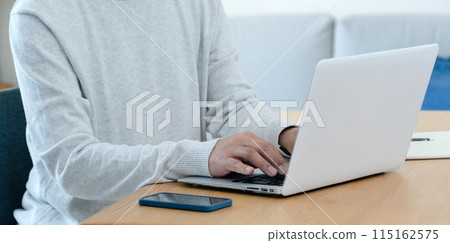 A middle-aged man thinking while looking at a computer 115162575