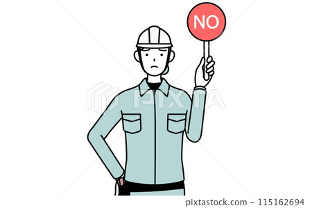 A female engineer in a helmet and work clothes holding a cross mark indicating an incorrect answer 115162694