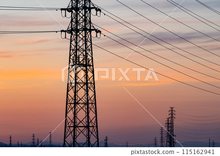 A row of power transmission towers and a sunset sky f-3 cool colors 115162941