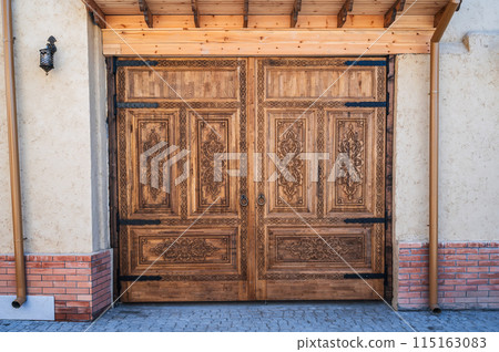 ancient carved wooden gate with oriental Tajik carved pattern ornament in traditional Kandakori style 115163083