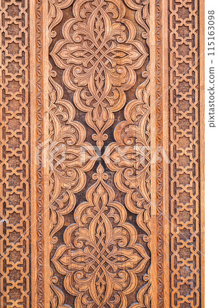 tajik kandakori patterns arabesque ornament on an vintage wooden carved door in Tajikistan closeup 115163098