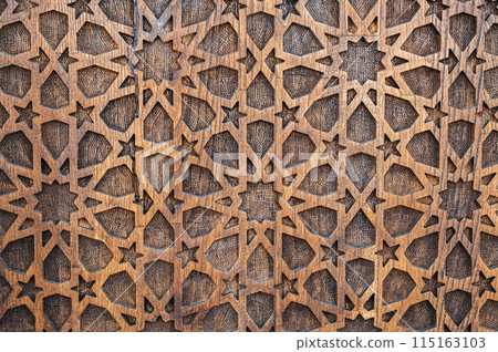 arabic Uzbek Islamic patterns ornament with stars on wooden carved door in Uzbekistan close-up 115163103