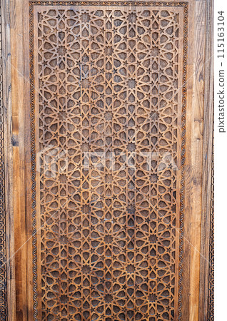 arabic Uzbek Islamic patterns ornament with stars on a modern wooden carved door in Uzbekistan arabic Uzbek Islamic patterns ornament with stars on a modern wooden carved door in Uzbekistan 115163104