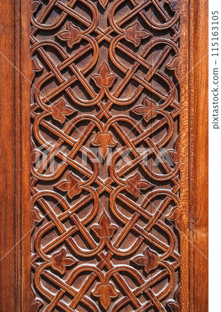 ancient floral oriental uzbek carved ornament pattern on brown wooden door in Uzbekistan in Tashkent 115163105