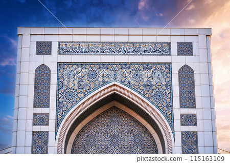 white marble tiles decorated with traditional Uzbek Islamic pattern ornament on the wall Minor Mosque in Tashkent in Uzbekistan on background of beautiful sky white marble tiles decorated with traditional Uzbek Islamic pattern ornament on the wall Minor Mosque in Tashkent in Uzbekistan on background of beautiful sky 115163109