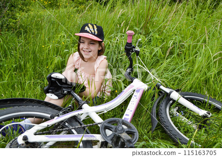 Young girl cyclist enjoy the beautiful sunrise on summer forest trail 115163705