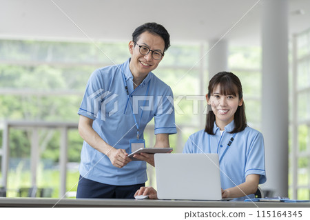 Image of a smiling facility staff member looking at the turtle's eyes Image of a smiling facility staff member looking at the turtle's eyes 115164345