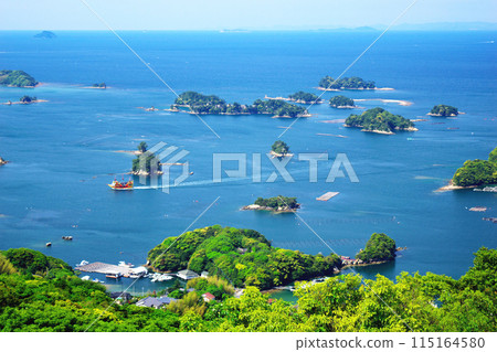 A view from Ishidake Observatory in Kujukushima, Saikai National Park, Nagasaki Prefecture. A sightseeing boat sailing through the archipelago. A view from Ishidake Observatory in Kujukushima, Saikai National Park, Nagasaki Prefecture. A sightseeing boat sailing through the archipelago. 115164580