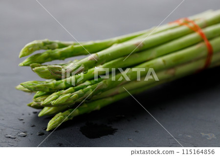 Fresh green asparagus bunch on wooden table. Fresh green asparagus bunch on wooden table. 115164856