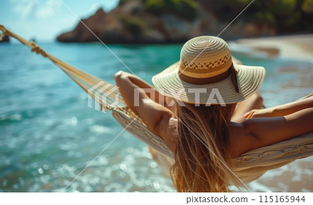 Woman Relaxing in a Hammock on a Beach With Blue Ocean in the Background Woman Relaxing in a Hammock on a Beach With Blue Ocean in the Background 115165944