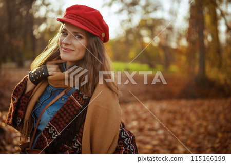 Portrait of stylish woman in red hat with scarf and gloves Portrait of stylish woman in red hat with scarf and gloves 115166199