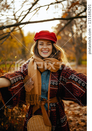 smiling young 40 years old woman in red hat rejoicing smiling young 40 years old woman in red hat rejoicing 115166201