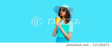 Summer portrait of beautiful young woman with cup of fresh juice wearing hat on blue background Summer portrait of beautiful young woman with cup of fresh juice wearing hat on blue background 115166873