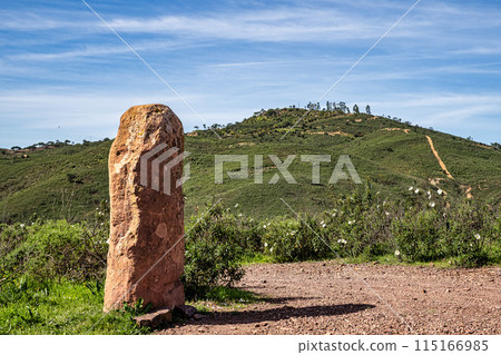 Sandstone Menir da Vilarinha, dating from 6000-4500 BC, in the dry hills near Vale Fuzeiros, Algarve, Portugal. Sandstone Menir da Vilarinha, dating from 6000-4500 BC, in the dry hills near Vale Fuzeiros, Algarve, Portugal. 115166985