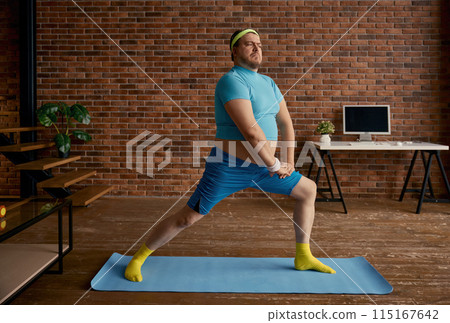 Plus size fat sportsman training at home feeling tired and exhausted Plus size fat sportsman training at home feeling tired and exhausted 115167642