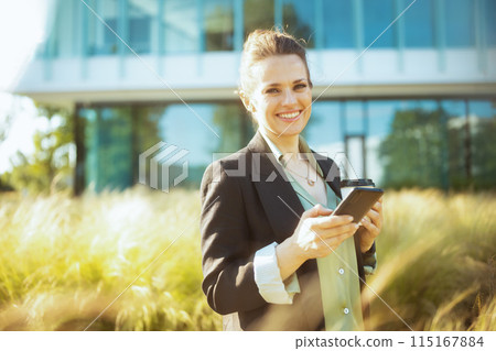 Portrait of happy modern woman worker in business district Portrait of happy modern woman worker in business district 115167884