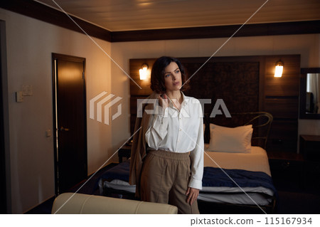 Portrait of thoughtful elegant business woman in hotel bedchamber 115167934