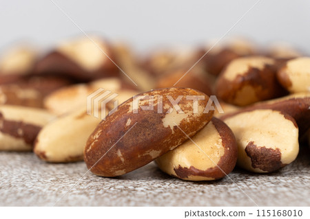 Macro brazil nuts on light grey background. 115168010