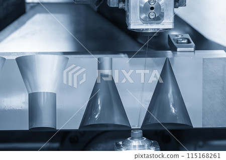 Closeup scene the wire EDM machine taper shape cutting the mold parts. 115168261