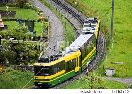 Wengen Alpbahn mountain railway approaching a curve just before Lauterbrunnen station Wengen Alpbahn mountain railway approaching a curve just before Lauterbrunnen station 115168560
