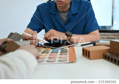 Senior decorator or interior designer choosing materials and color for indoor decor. House renovation concept Senior decorator or interior designer choosing materials and color for indoor decor. House renovation concept 115169102
