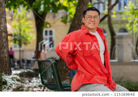 Asian mature man touching injured sore back backache suffering lower lumbar discomfort muscle pain Asian mature man touching injured sore back backache suffering lower lumbar discomfort muscle pain 115169648