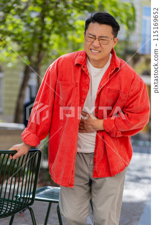Asian middle-aged man feeling sudden strong abdominal stomach ache gastritis problem diarrhea Asian middle-aged man feeling sudden strong abdominal stomach ache gastritis problem diarrhea 115169652