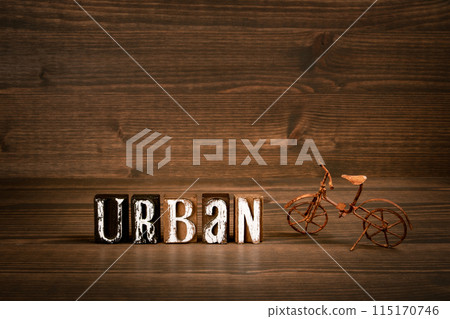 URBAN. Word from alphabet blocks and rusty miniature bicycle on wood texture background URBAN. Word from alphabet blocks and rusty miniature bicycle on wood texture background 115170746