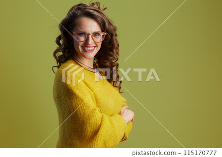 happy fit 40 years old woman in sweater and glasses on green 115170777