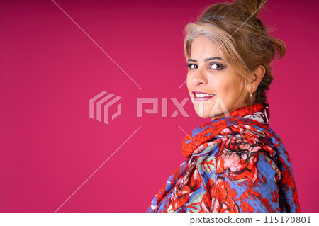 Pretty young woman with colorful shawl looking at the camera, with copy space, 115170801