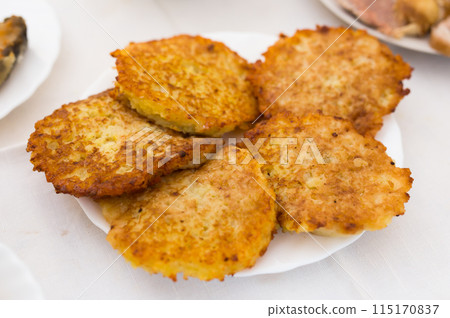 Potato pancakes with sour cream on white plate 115170837