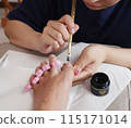 A woman having a nail treatment 115171014