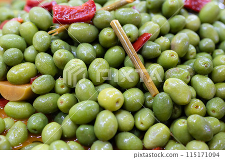Marinated green olives background. Spanish appetizer 115171094